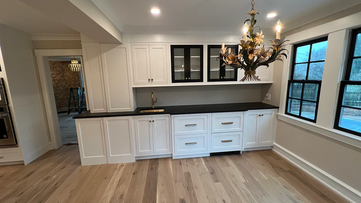 Tailored serving cabinetry with contrasting counters and display storage