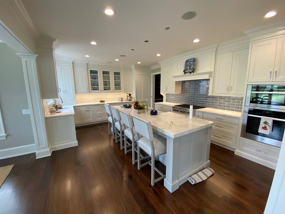 Traditional kitchen renovation with detailed white cabinetry and a long island